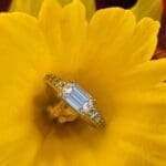 Platinum Emerald cut diamond New Horizon in yellow flower Platinum Emerald cut diamond New Horizon in yellow flower